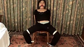 Asian bondage victim bound to a chair